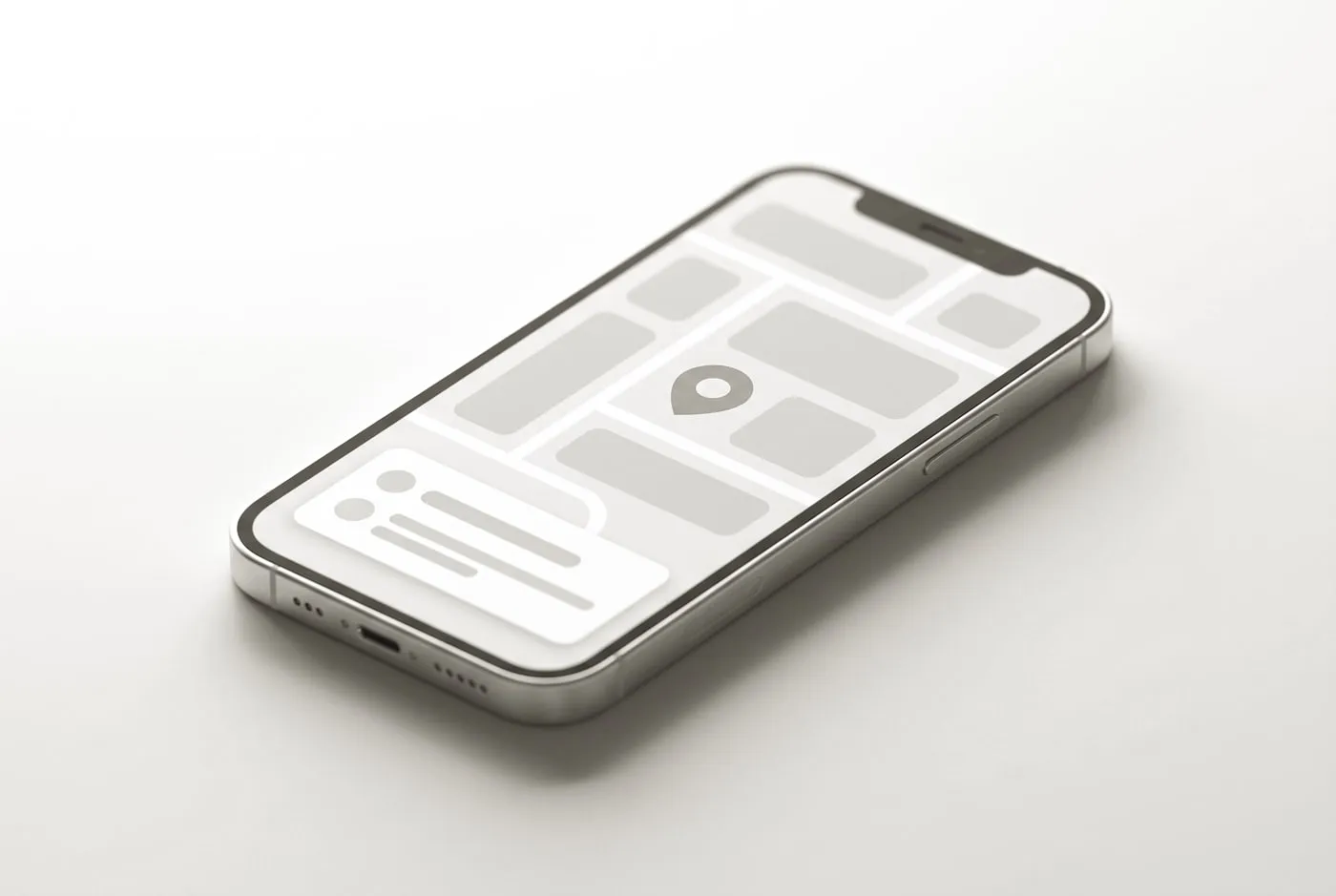 A phone lying flat showing a map interface with a teal location pin and a listing card below it.